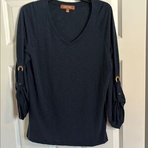 Navy blue vneck knit with sleeve detail and gold grommets.